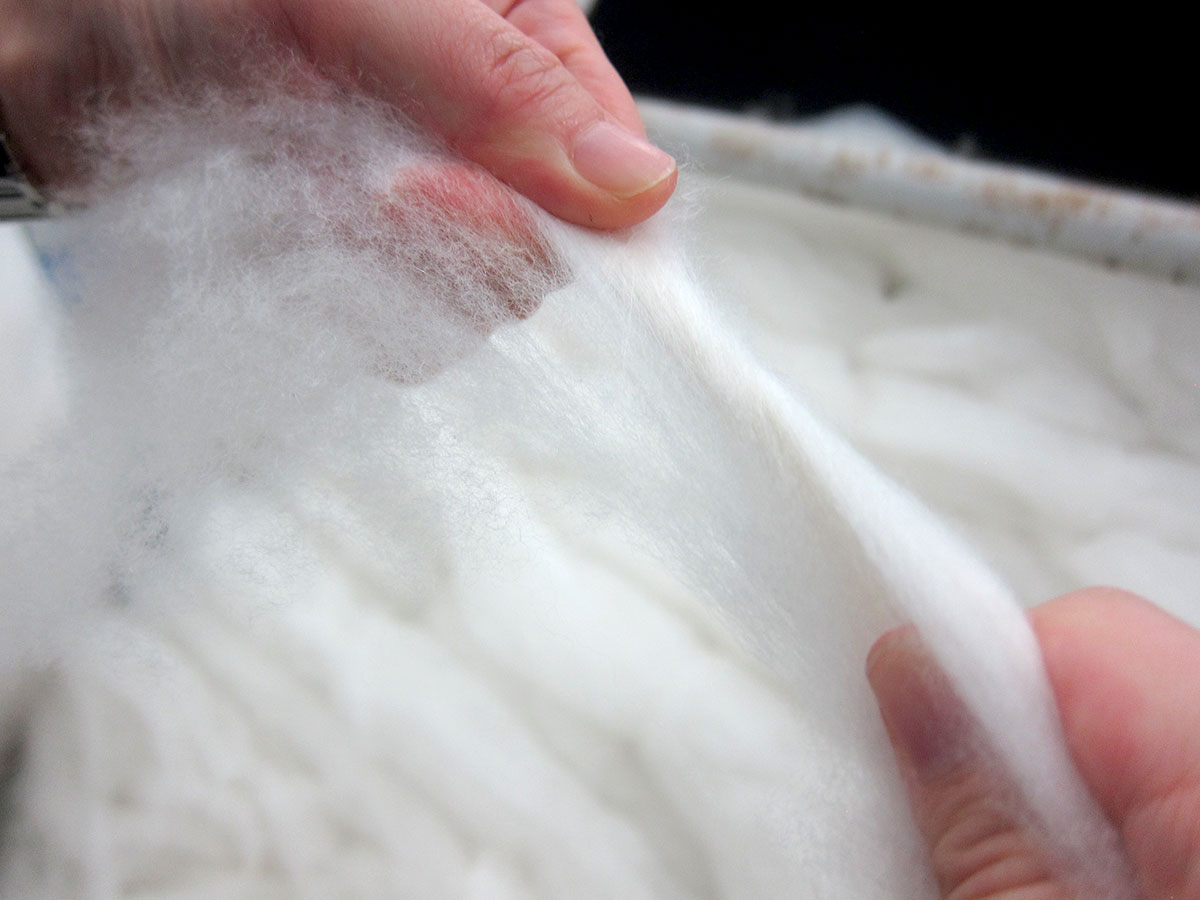 Examining the length, diameter, and color of the cashmere fiber.